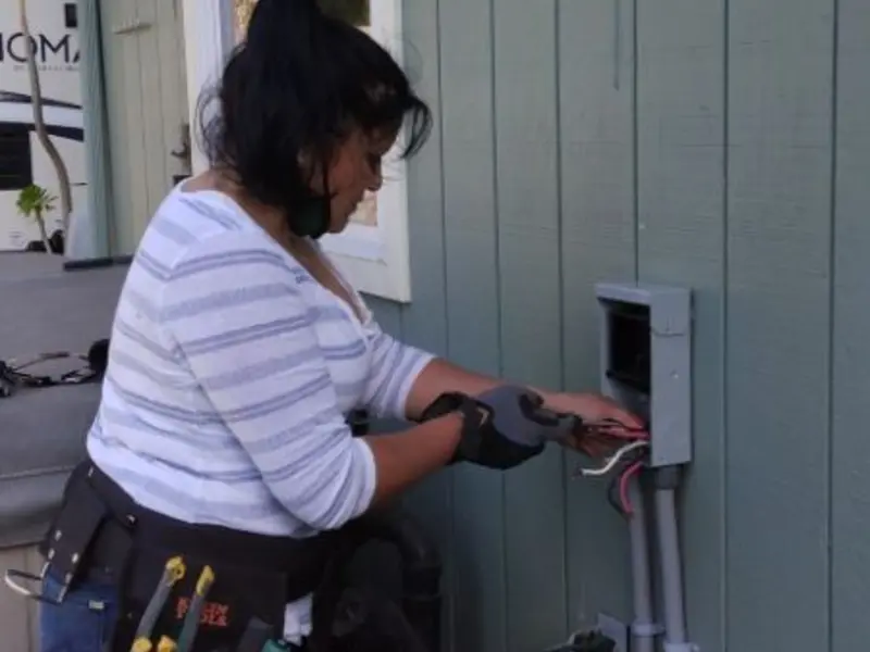 Licensed electrician wiring an exterior subpanel in Ojus