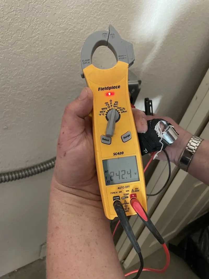 Voltage testing with clamp meter during Electrical Installation Services in Ojus
